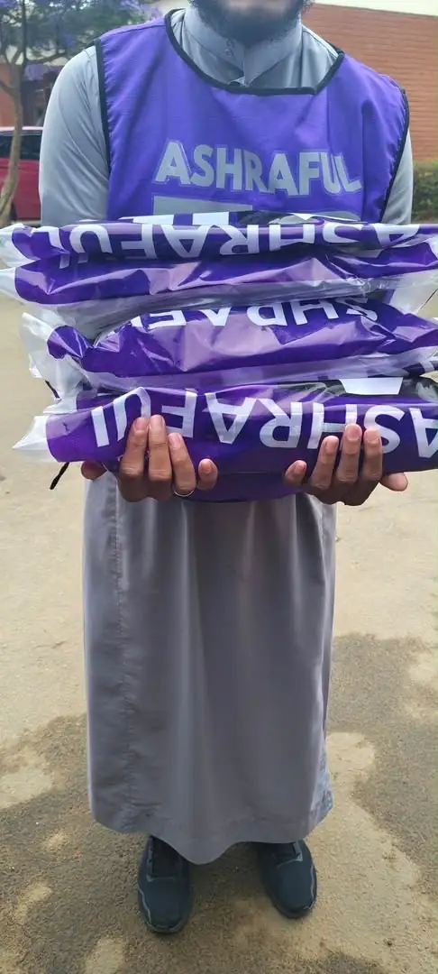 Ashraful Aid volunteer with branded bedding packs
