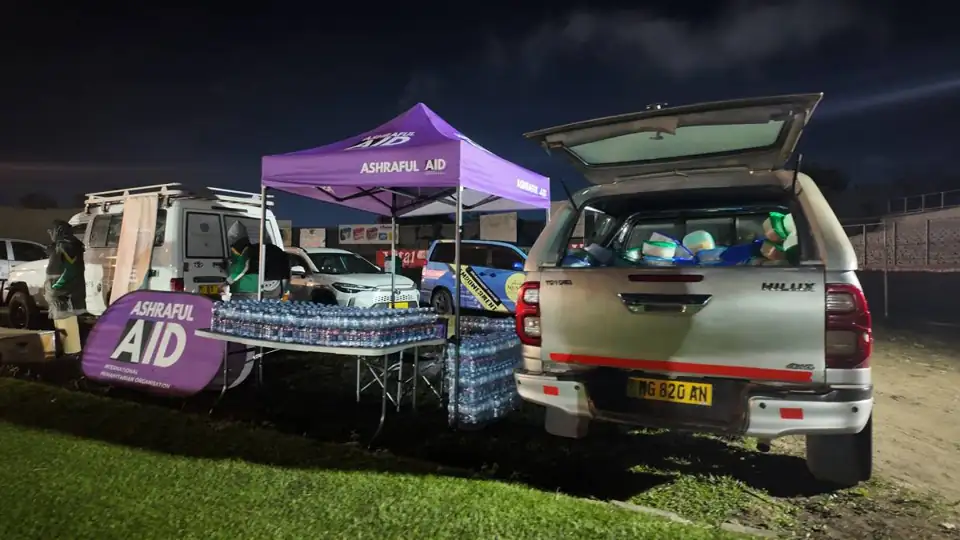 Ashraful Aid gazebo and vehicle set up for an evening winter distribution